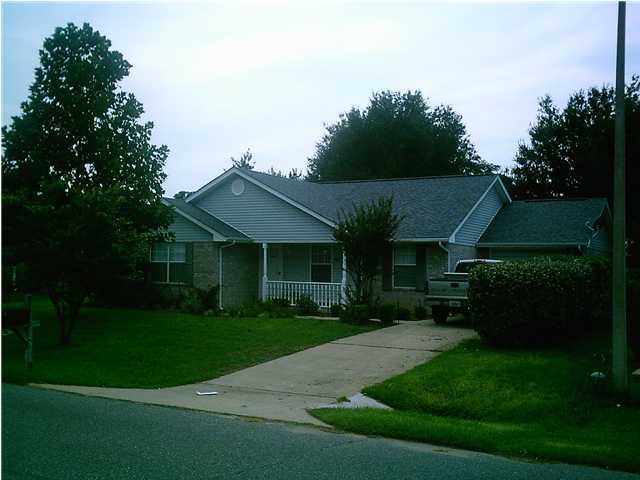 105 Steeplechase Drive Crestview, FL 32539 - Photo 1 of 11 a front view of a house with garden