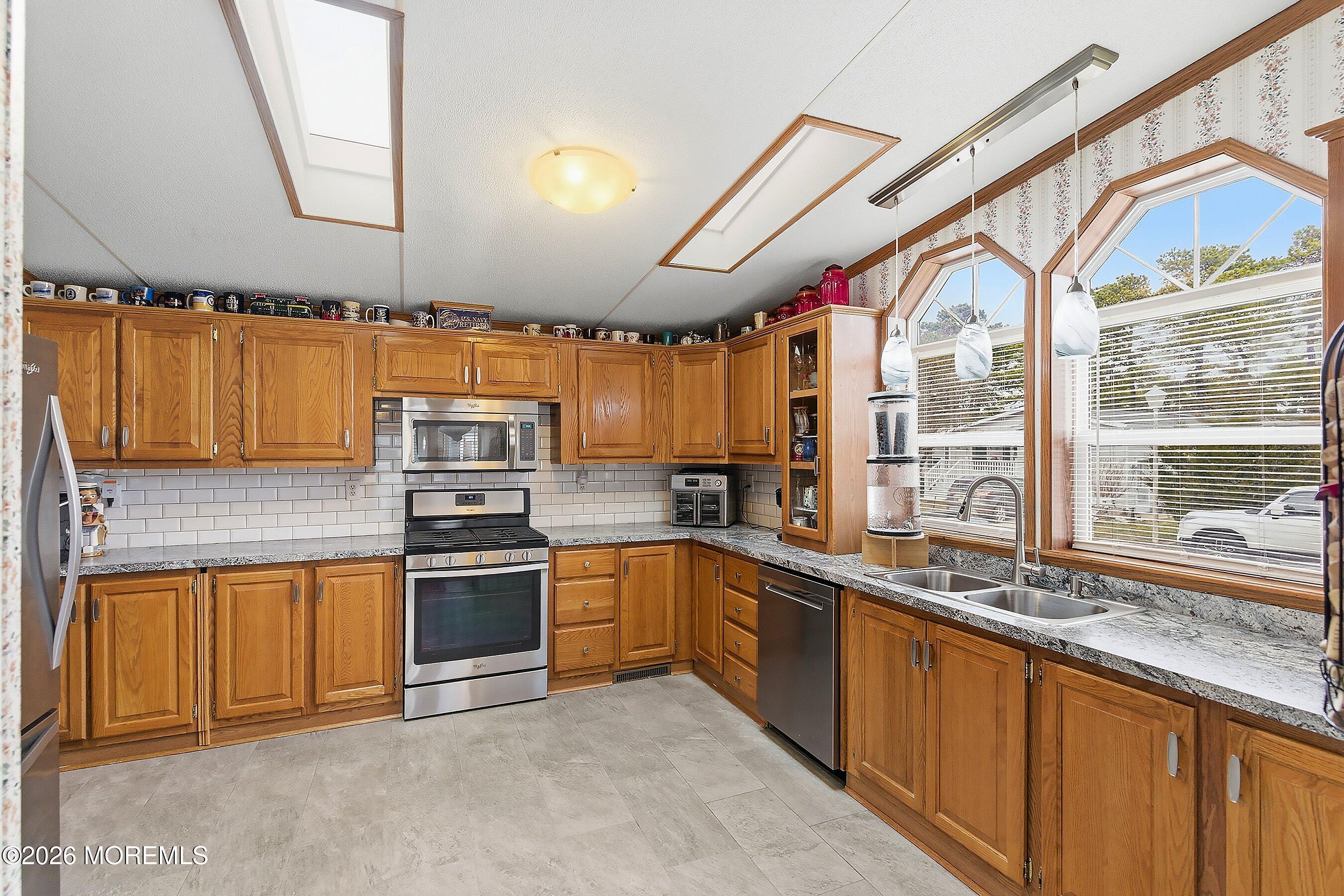 536 Momosa Way Whiting, NJ 08759 - Photo 16 of 54 a kitchen with stainless steel appliances granite countertop a sink and a stove