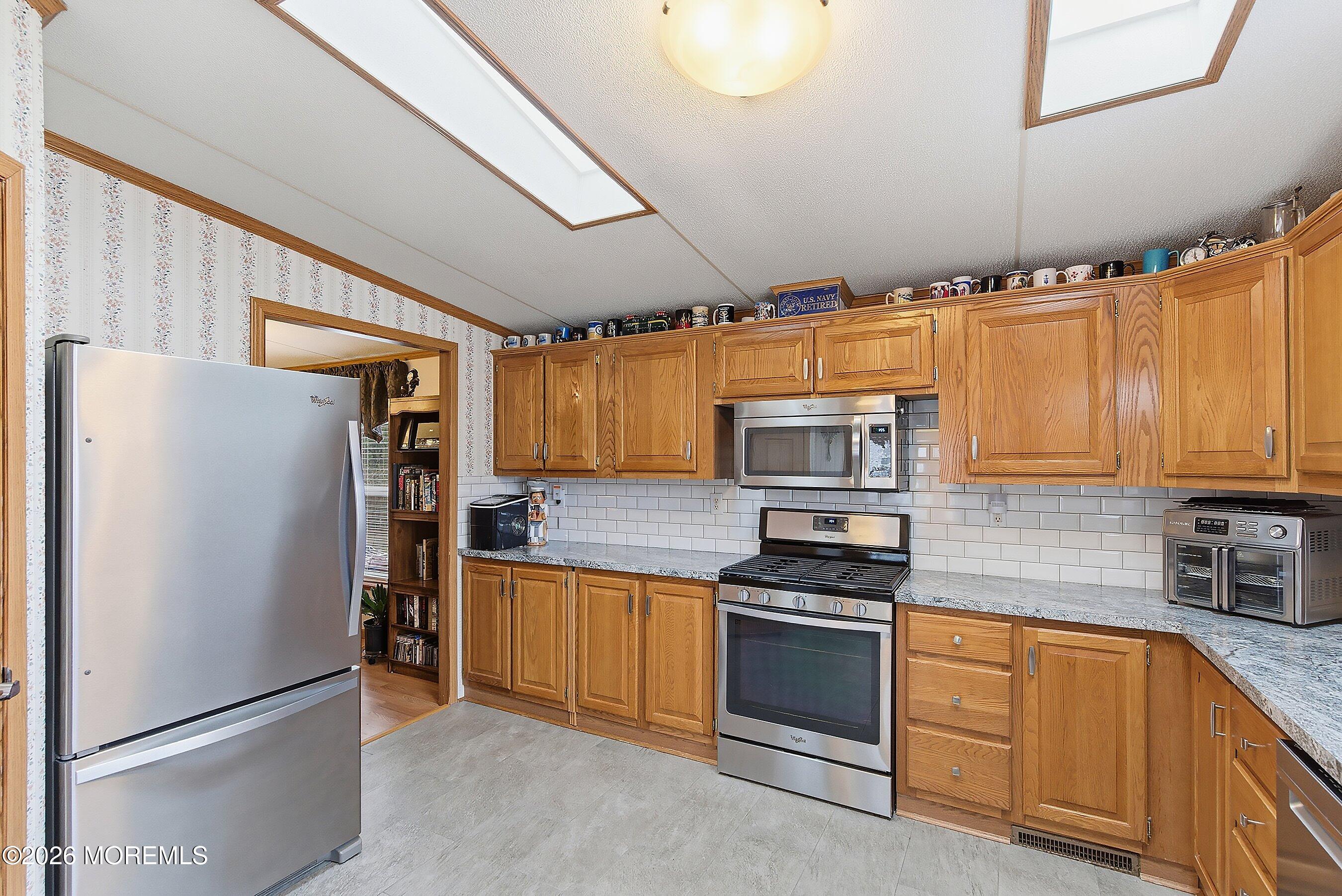 536 Momosa Way Whiting, NJ 08759 - Photo 17 of 54 a kitchen with granite countertop a refrigerator stove and sink
