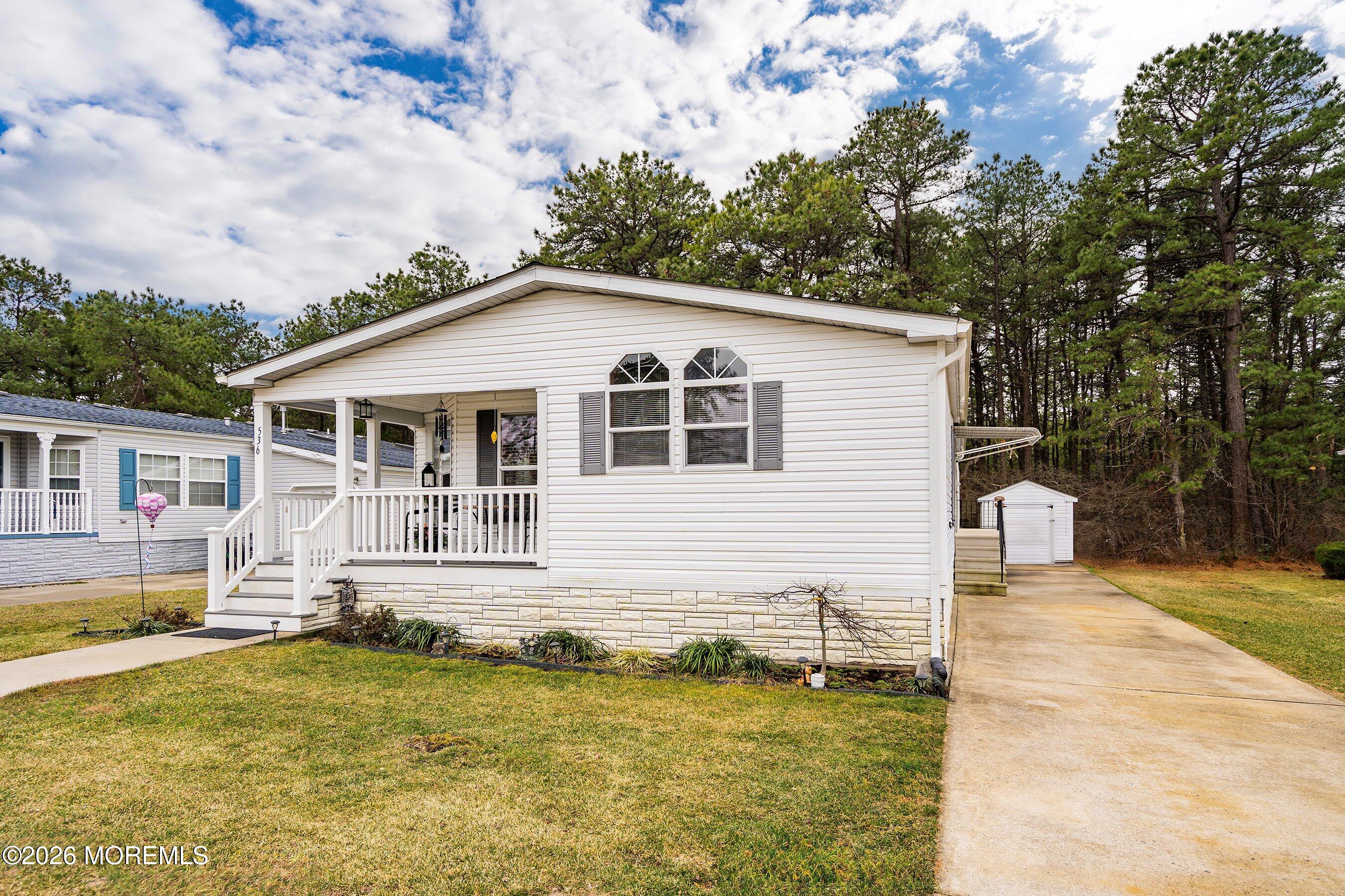 536 Momosa Way Whiting, NJ 08759 - Photo 6 of 54 a front view of a house with a yard table and chairs