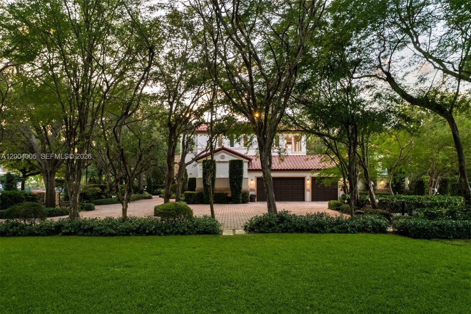 255 Cocoplum Road Coral Gables, FL 33143 - Photo 11 of 29 a front view of a house with a garden