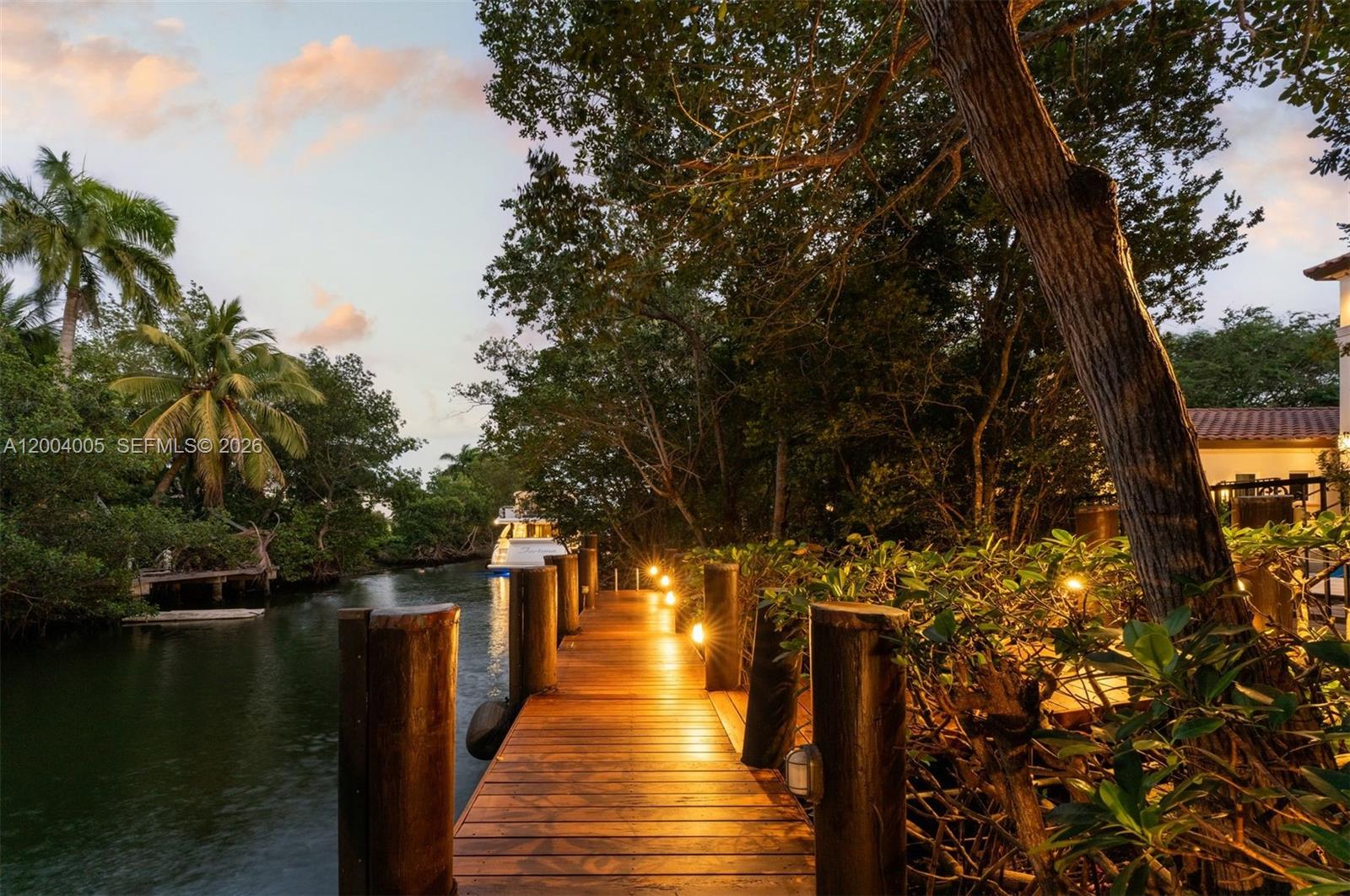 255 Cocoplum Road Coral Gables, FL 33143 - Photo 15 of 29 a view of a lake with wooden bridge