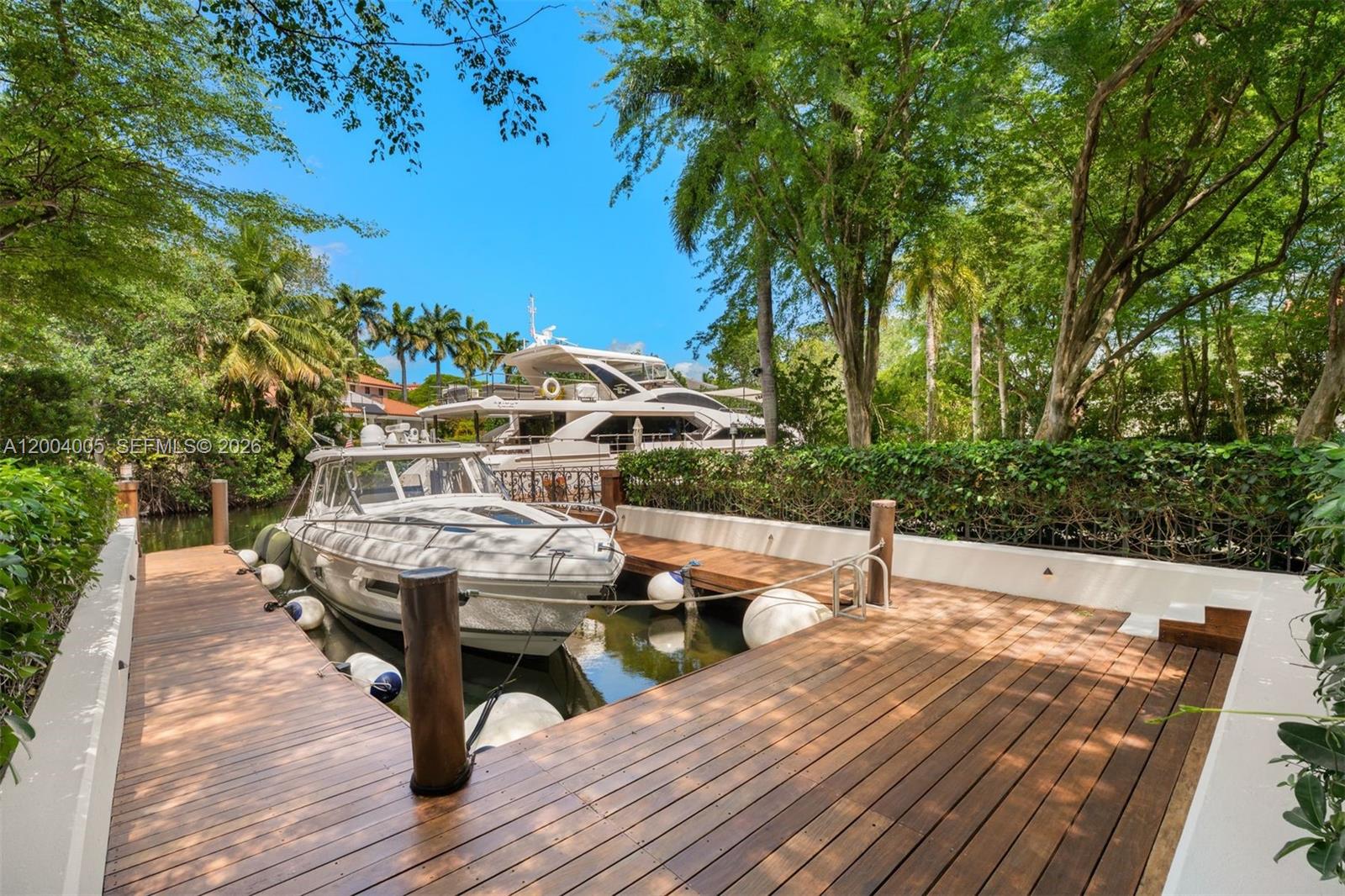 255 Cocoplum Road Coral Gables, FL 33143 - Photo 17 of 29 a terrace with outdoor seating and trees