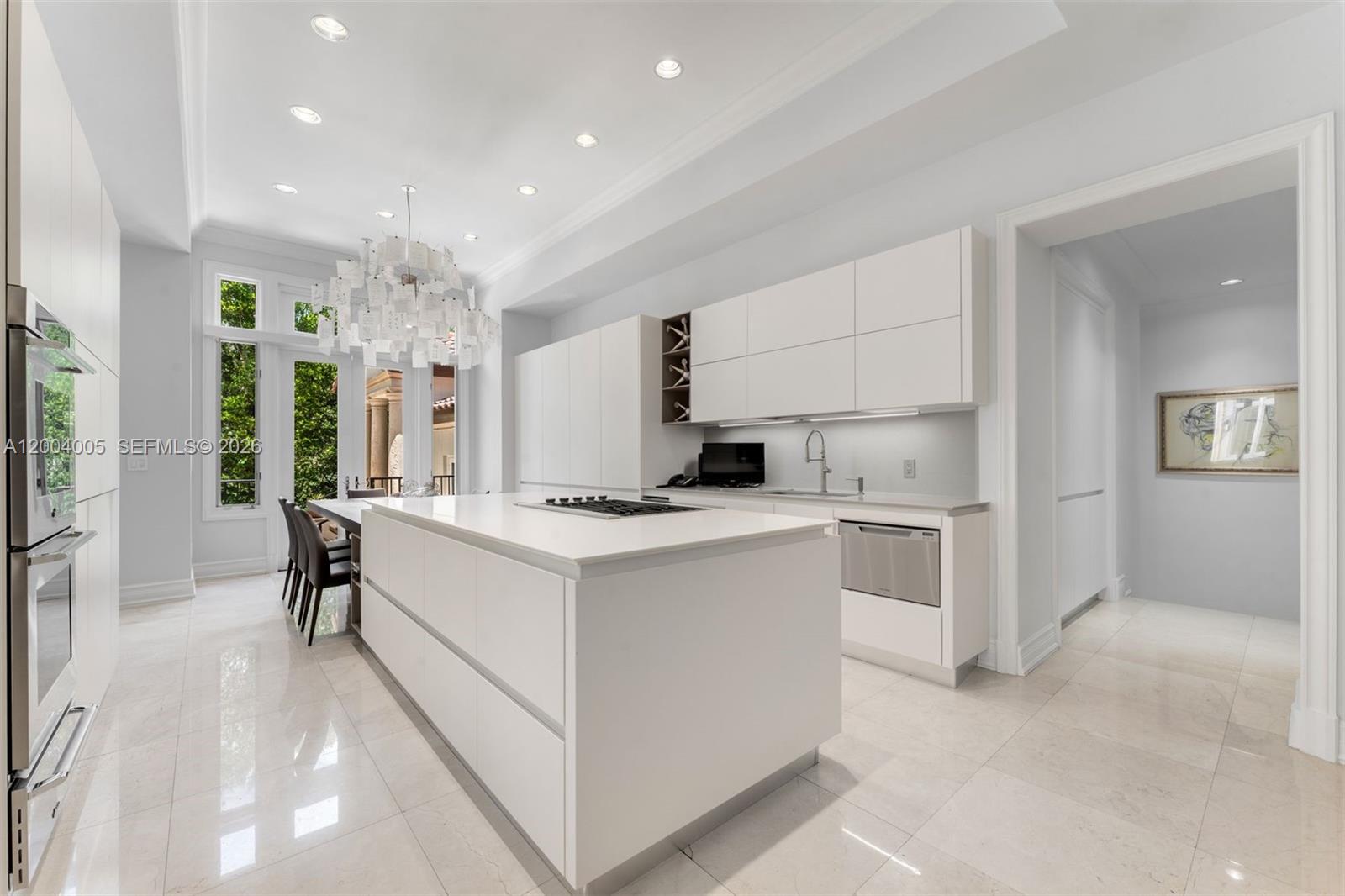 255 Cocoplum Road Coral Gables, FL 33143 - Photo 20 of 29 a kitchen that has a lot of cabinets in it and appliances