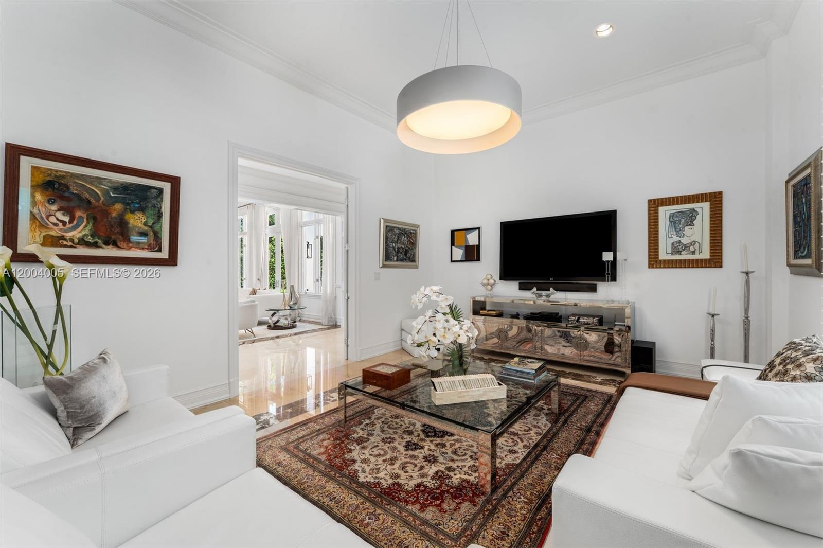 255 Cocoplum Road Coral Gables, FL 33143 - Photo 23 of 29 a living room with furniture and a flat screen tv