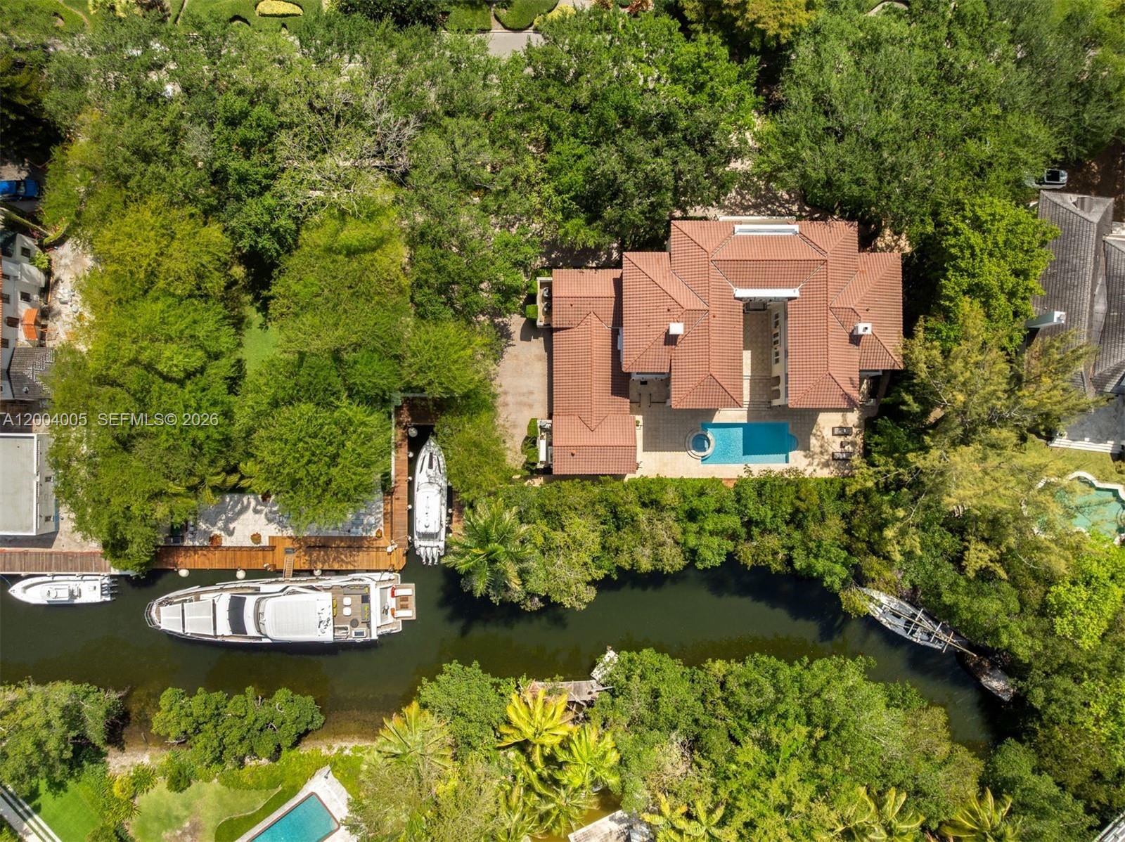 255 Cocoplum Road Coral Gables, FL 33143 - Photo 27 of 29 an aerial view of a house with a yard swimming pool and green space