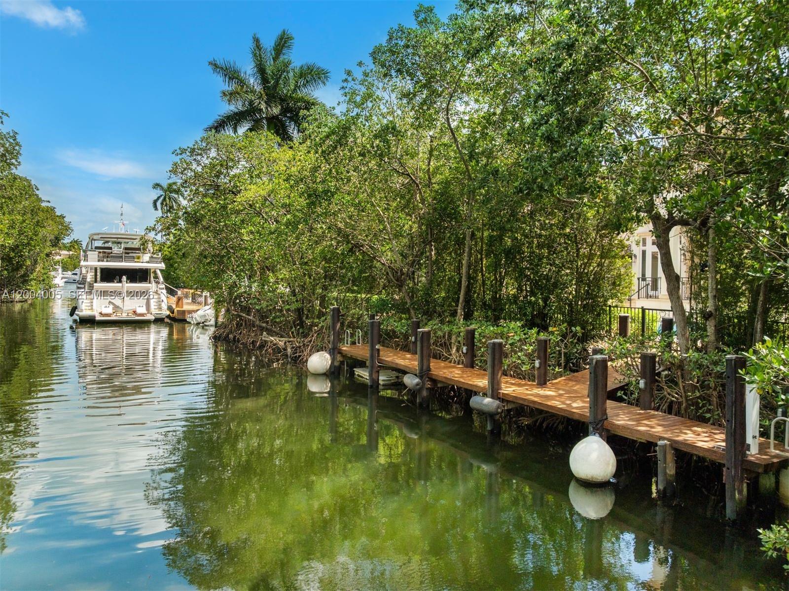 255 Cocoplum Road Coral Gables, FL 33143 - Photo 28 of 29 a view of a lake with a house