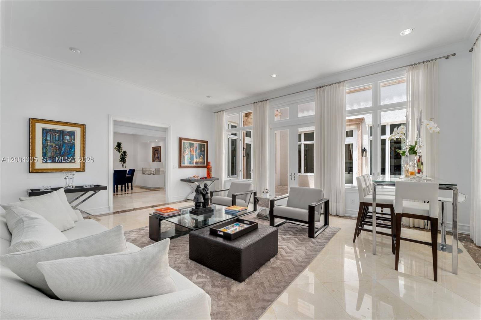 255 Cocoplum Road Coral Gables, FL 33143 - Photo 4 of 29 a living room with furniture and a large window