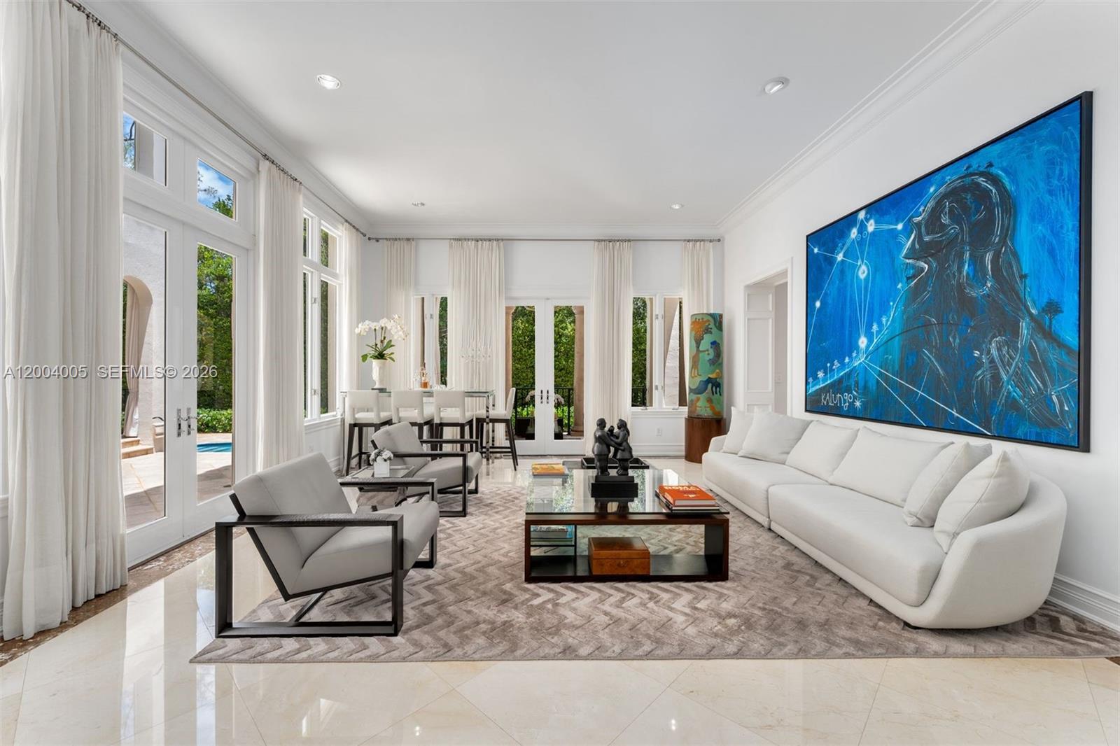 255 Cocoplum Road Coral Gables, FL 33143 - Photo 5 of 29 a living room with furniture and large window with garden view