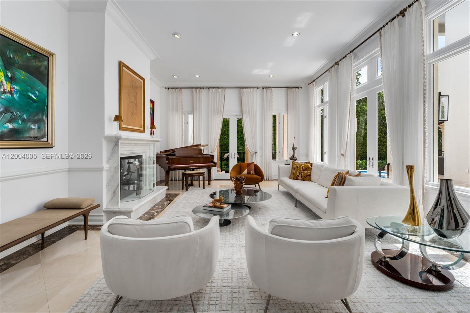 255 Cocoplum Road Coral Gables, FL 33143 - Photo 6 of 29 a living room with furniture a floor to ceiling window and a flat screen tv