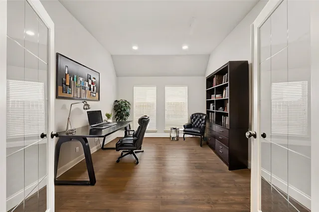 a view of a workspace with furniture and a book shelf