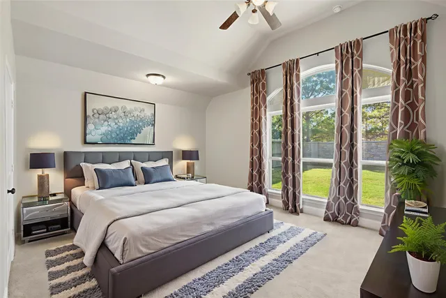 a bedroom with a large bed and a potted plant