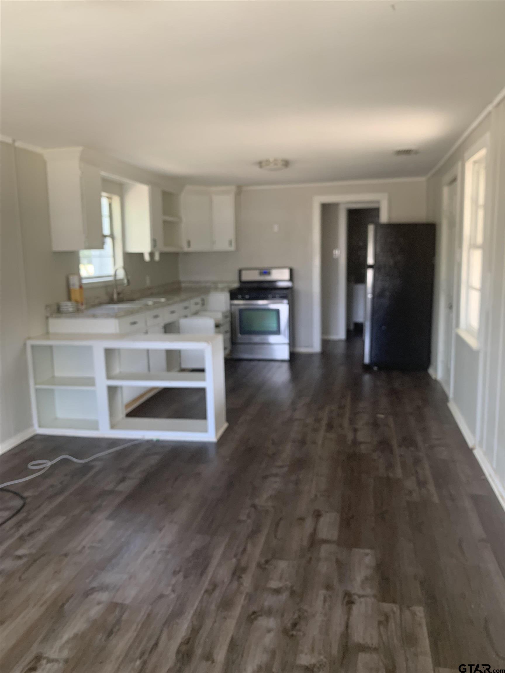 2722 Bunche Street Tyler, TX 75701 - Photo 2 of 6 a view of a living room hardwood floor and a kitchen