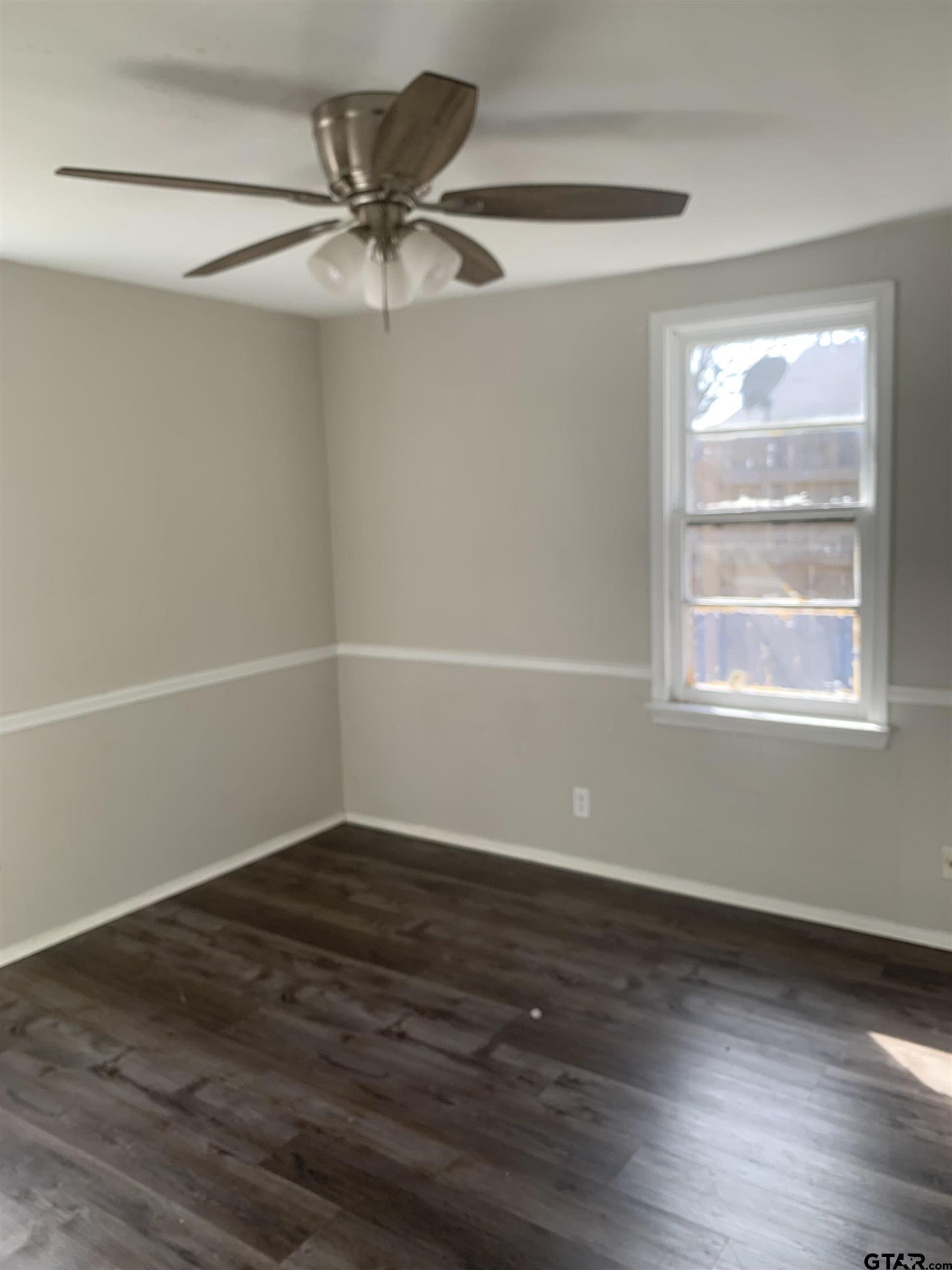 2722 Bunche Street Tyler, TX 75701 - Photo 4 of 6 a view of an empty room with wooden floor and a window