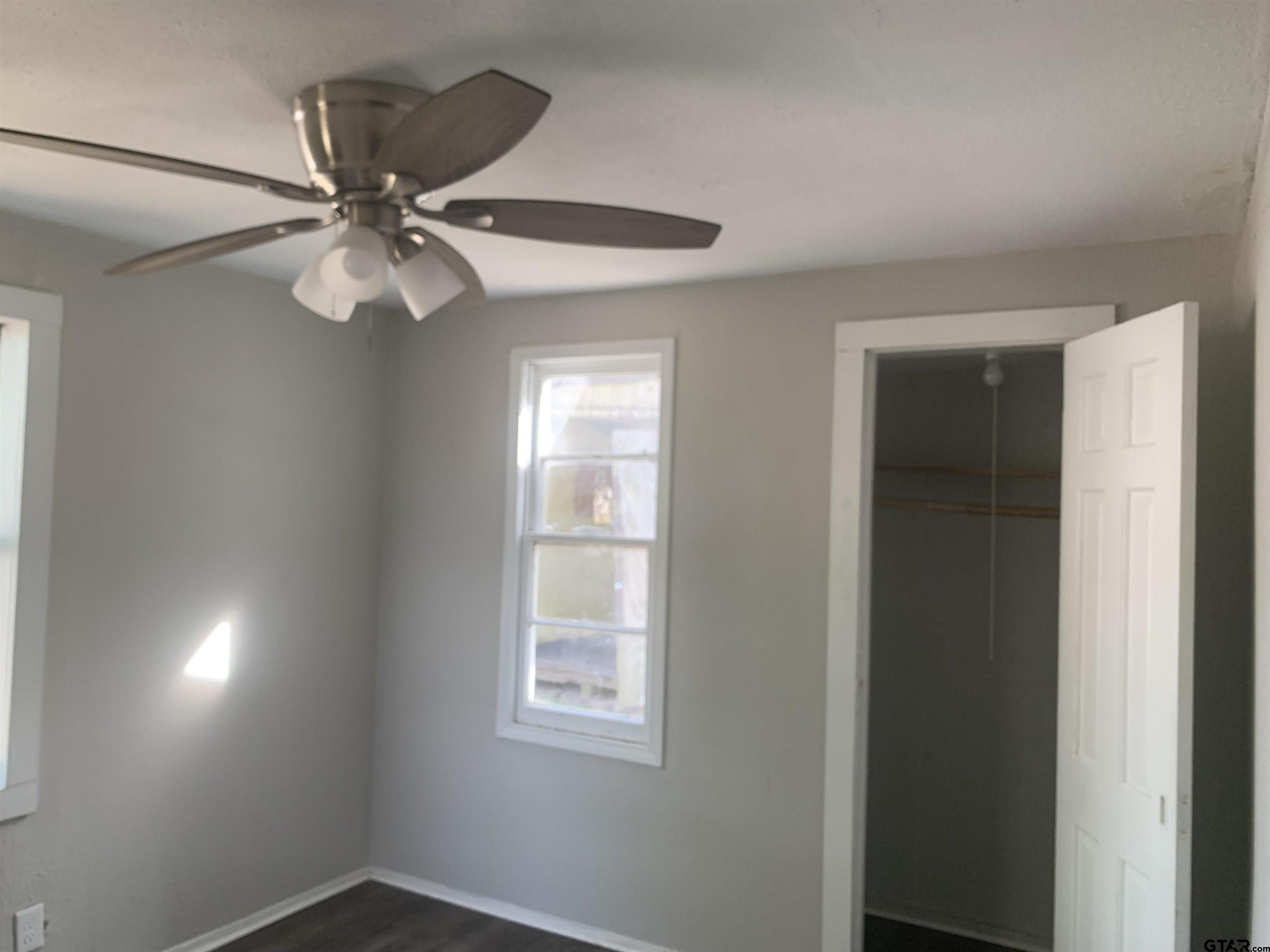 2722 Bunche Street Tyler, TX 75701 - Photo 5 of 6 an empty room with windows and fan