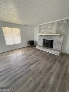 an empty room with windows and fireplace