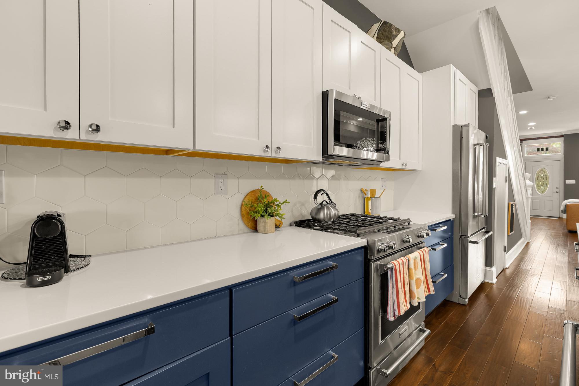 421 10th Street Northeast Washington, DC 20002 - Photo 17 of 61 a kitchen with stainless steel appliances granite countertop a sink a stove and a microwave
