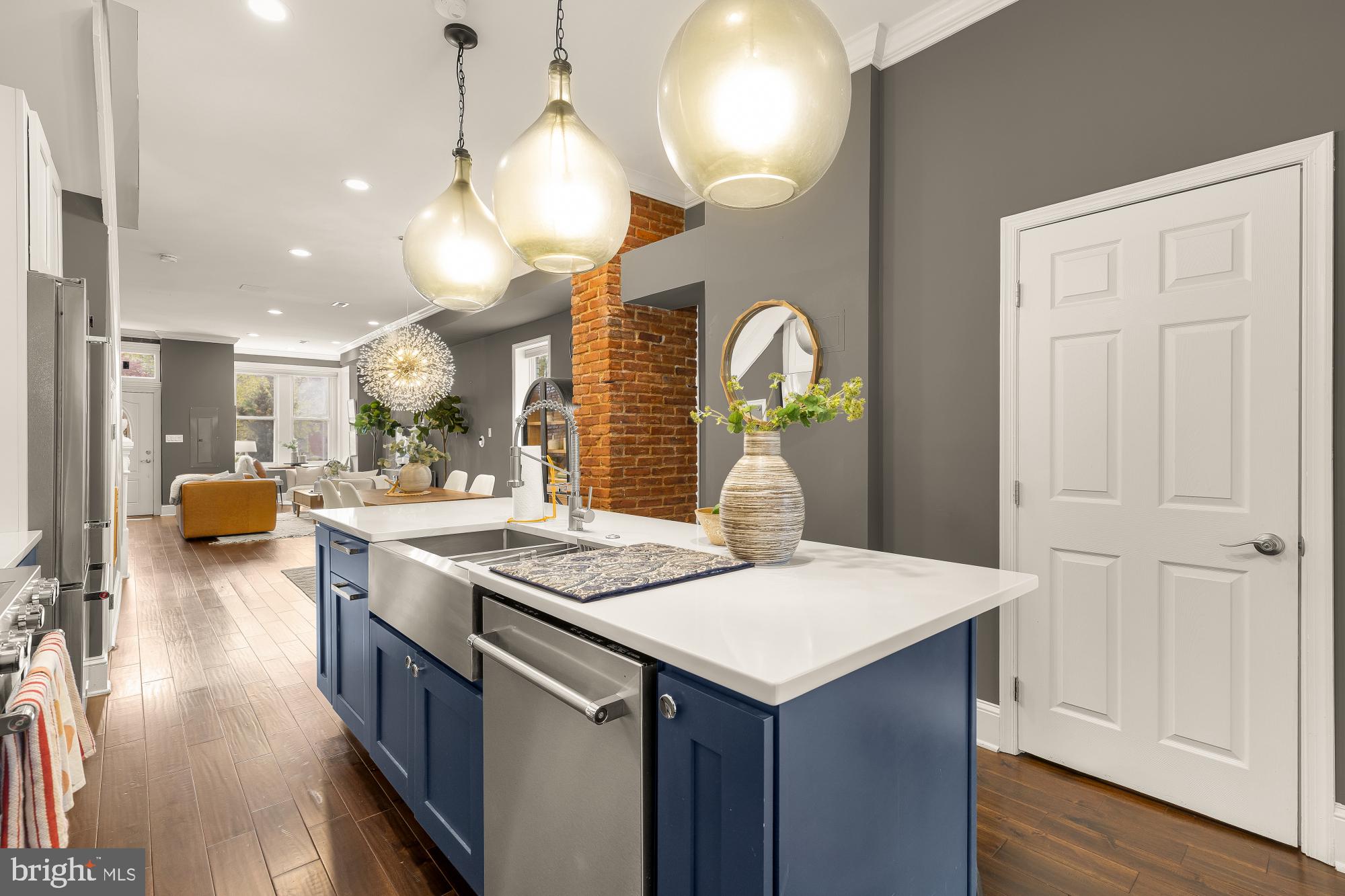 421 10th Street Northeast Washington, DC 20002 - Photo 19 of 61 a kitchen with a sink a stove and chairs with wooden floor