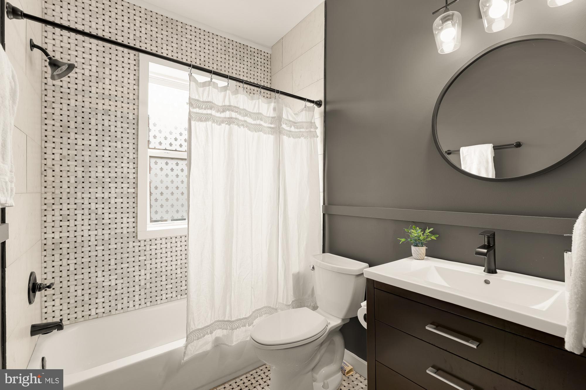 421 10th Street Northeast Washington, DC 20002 - Photo 27 of 61 a bathroom with a sink a toilet and a mirror