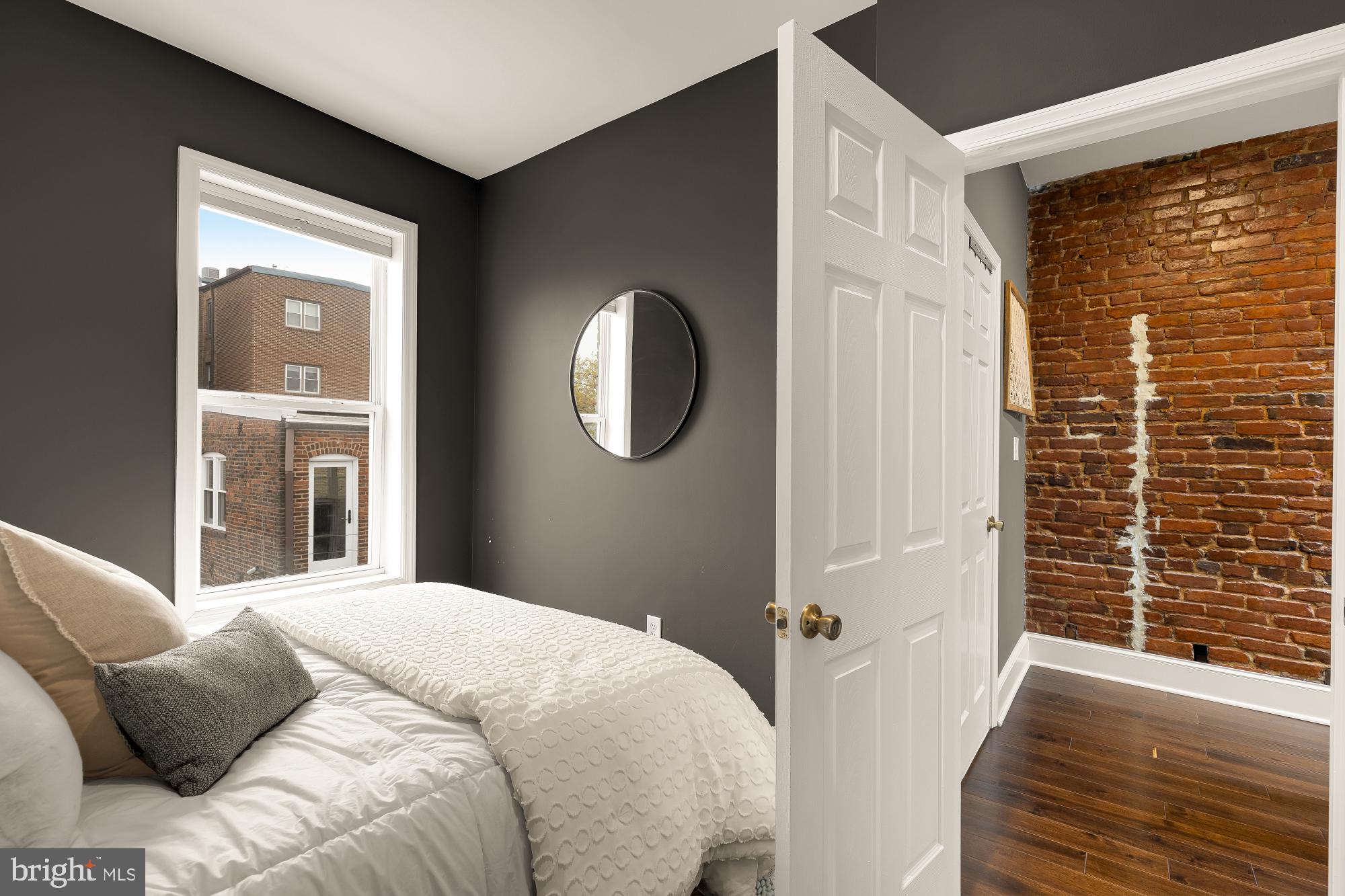 421 10th Street Northeast Washington, DC 20002 - Photo 29 of 61 a bedroom with a bed and a mirror