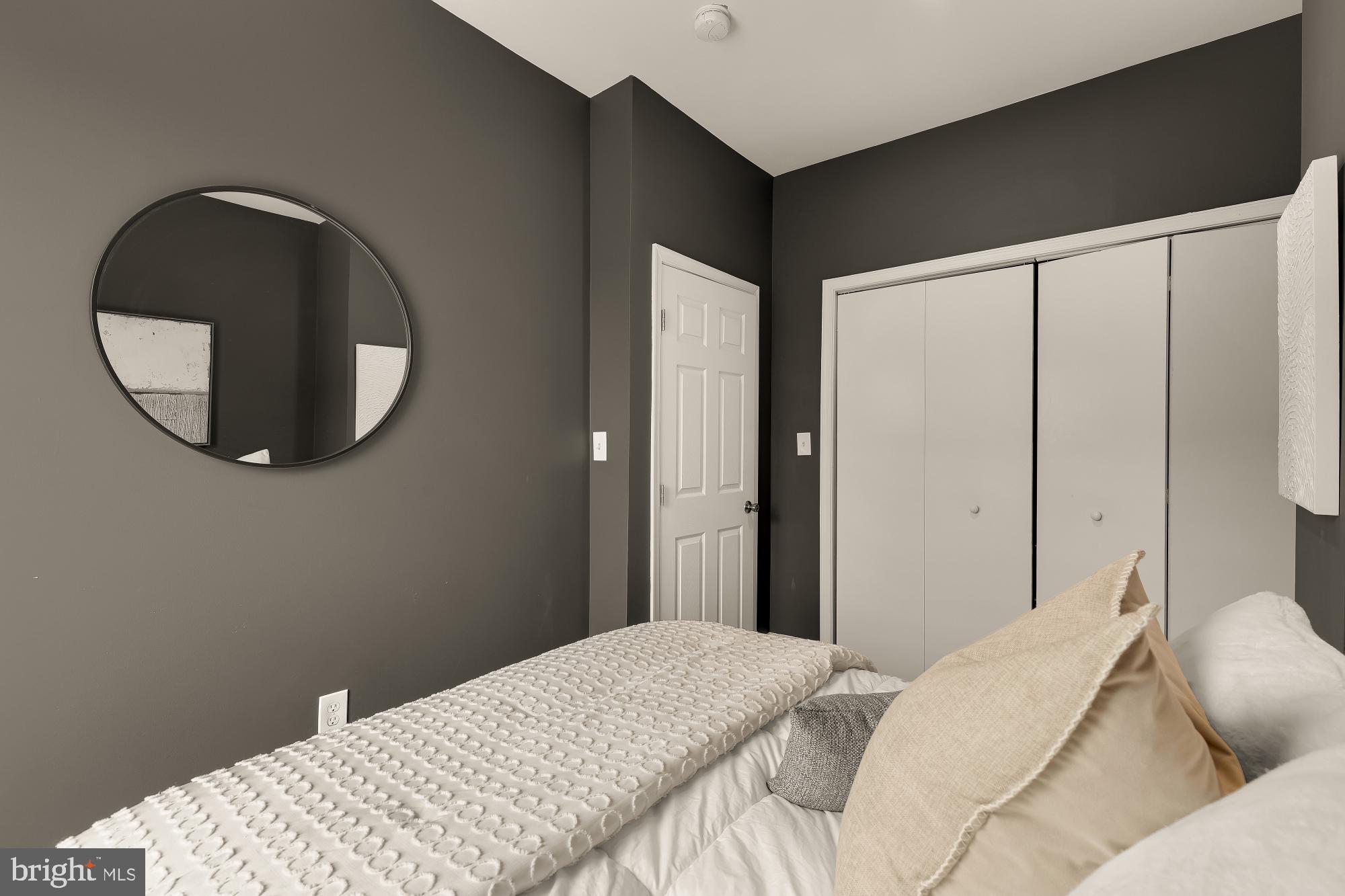 421 10th Street Northeast Washington, DC 20002 - Photo 30 of 61 a bedroom with a bed and a mirror