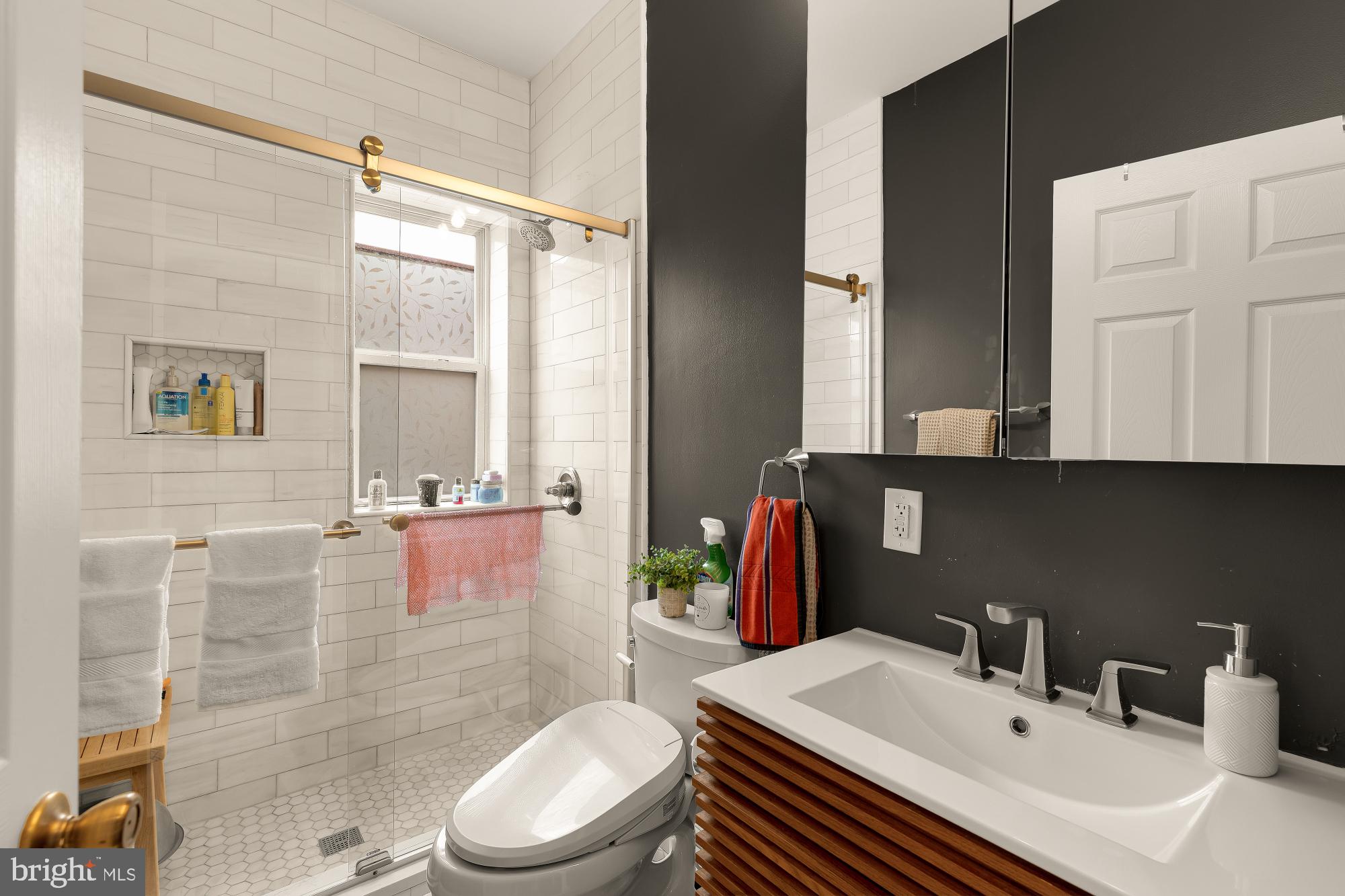 421 10th Street Northeast Washington, DC 20002 - Photo 35 of 61 a bathroom with a sink a toilet and shower