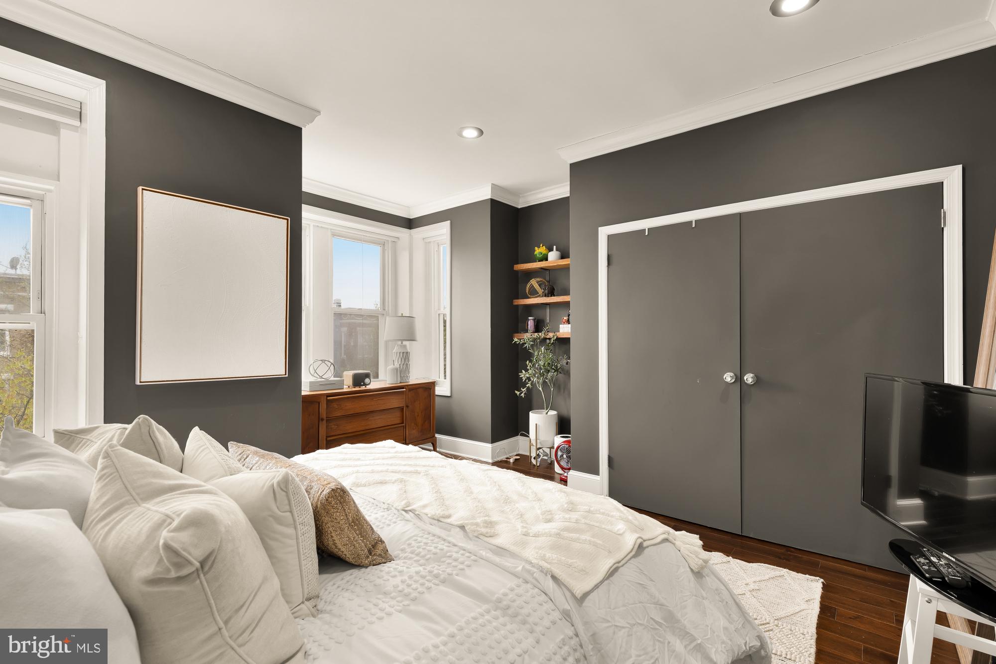 421 10th Street Northeast Washington, DC 20002 - Photo 37 of 61 a bedroom with a bed and a flat tv screen next to a window