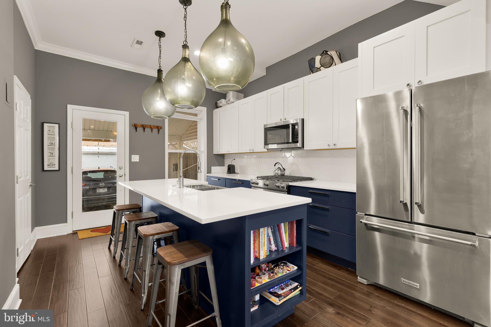 421 10th Street Northeast Washington, DC 20002 - Photo 4 of 61 a kitchen with kitchen island granite countertop a sink appliances and wooden floor
