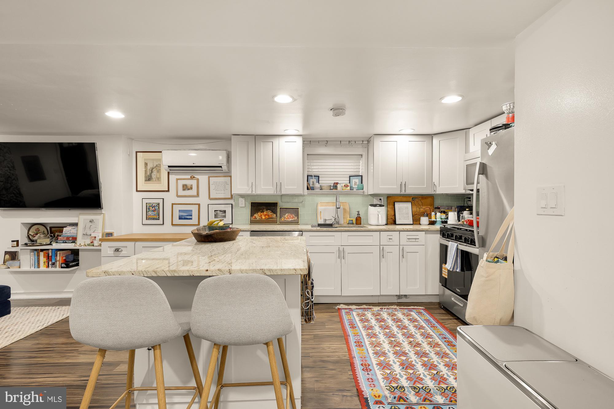 421 10th Street Northeast Washington, DC 20002 - Photo 46 of 61 a kitchen with stainless steel appliances granite countertop a stove a sink a microwave a refrigerator and cabinets