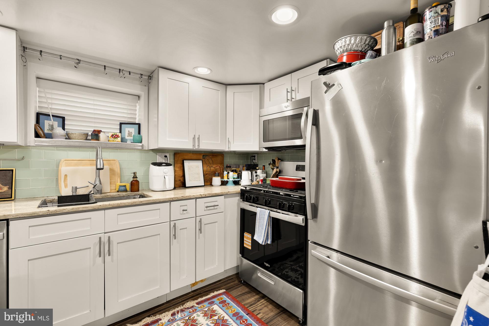 421 10th Street Northeast Washington, DC 20002 - Photo 49 of 61 a kitchen with stainless steel appliances a refrigerator sink and cabinets