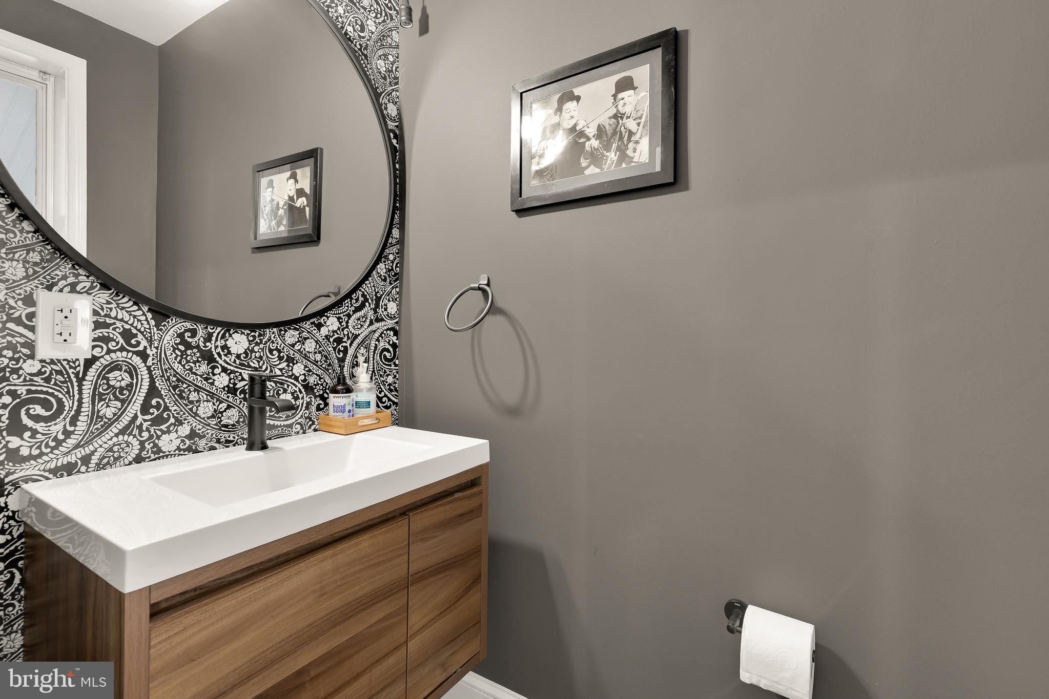 421 10th Street Northeast Washington, DC 20002 - Photo 5 of 61 a bathroom with a sink mirror and vanity