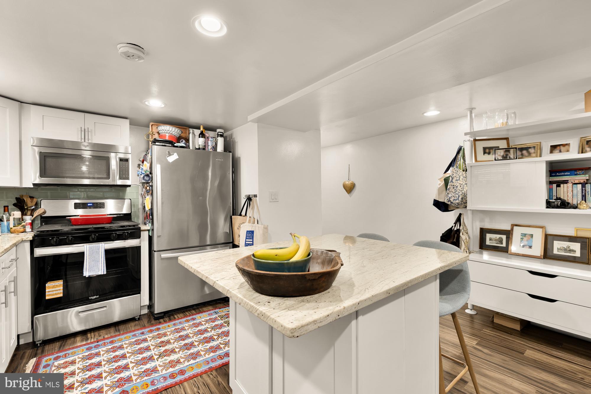 421 10th Street Northeast Washington, DC 20002 - Photo 53 of 61 a kitchen with stainless steel appliances kitchen island granite countertop a sink and a refrigerator