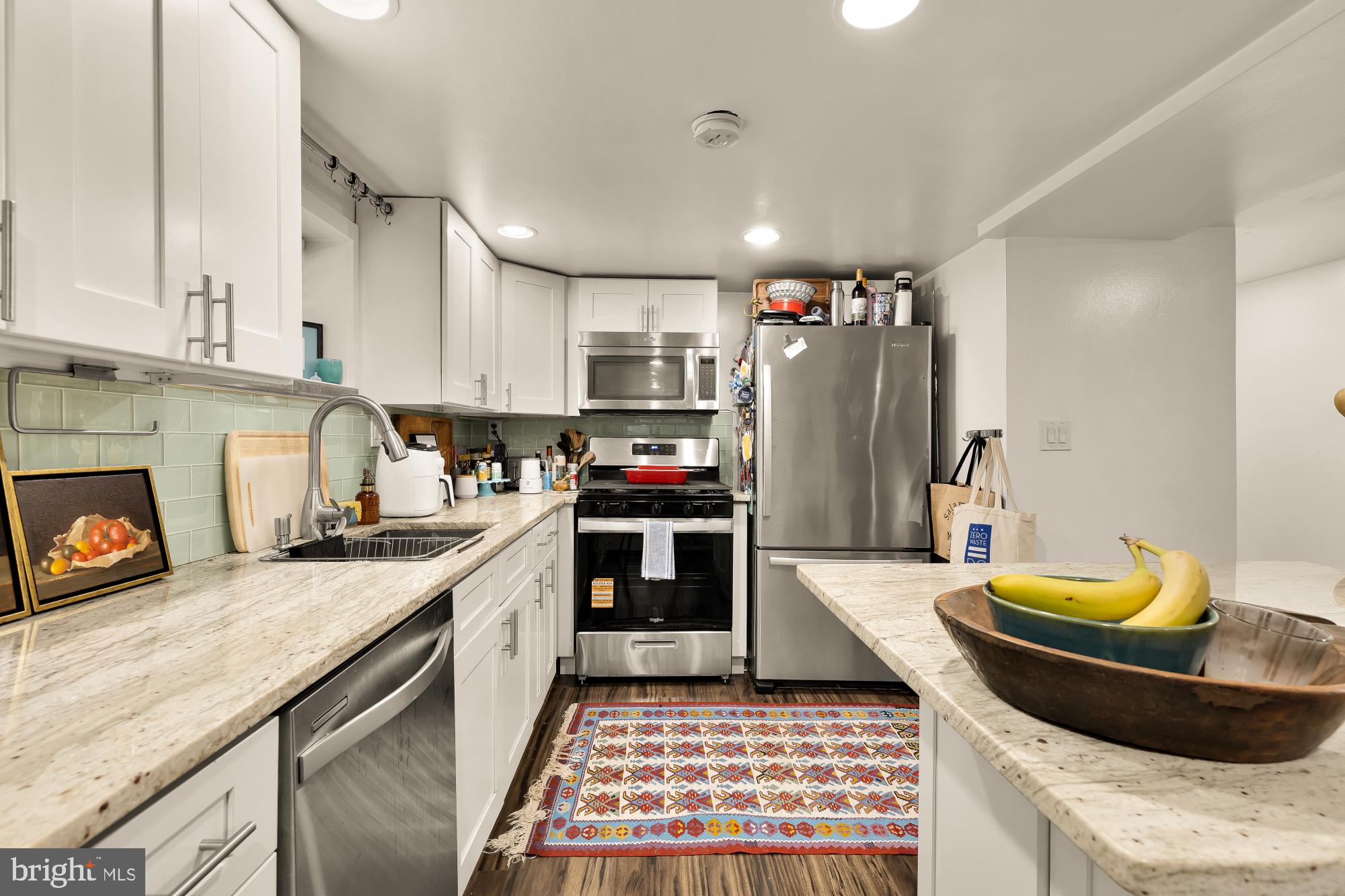 421 10th Street Northeast Washington, DC 20002 - Photo 54 of 61 a kitchen with stainless steel appliances granite countertop a sink stove and refrigerator