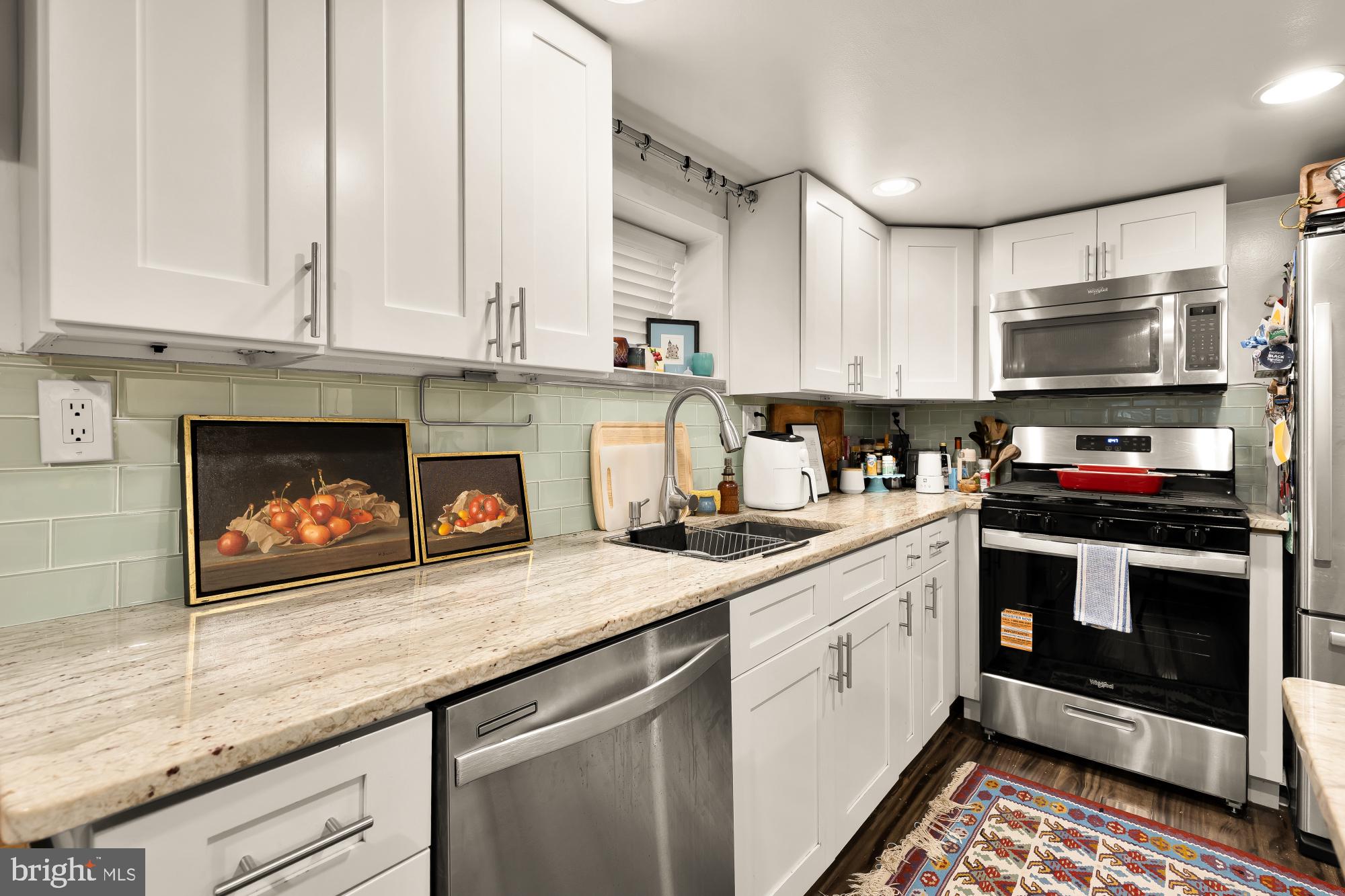 421 10th Street Northeast Washington, DC 20002 - Photo 55 of 61 a kitchen with stainless steel appliances granite countertop a stove a sink and a microwave
