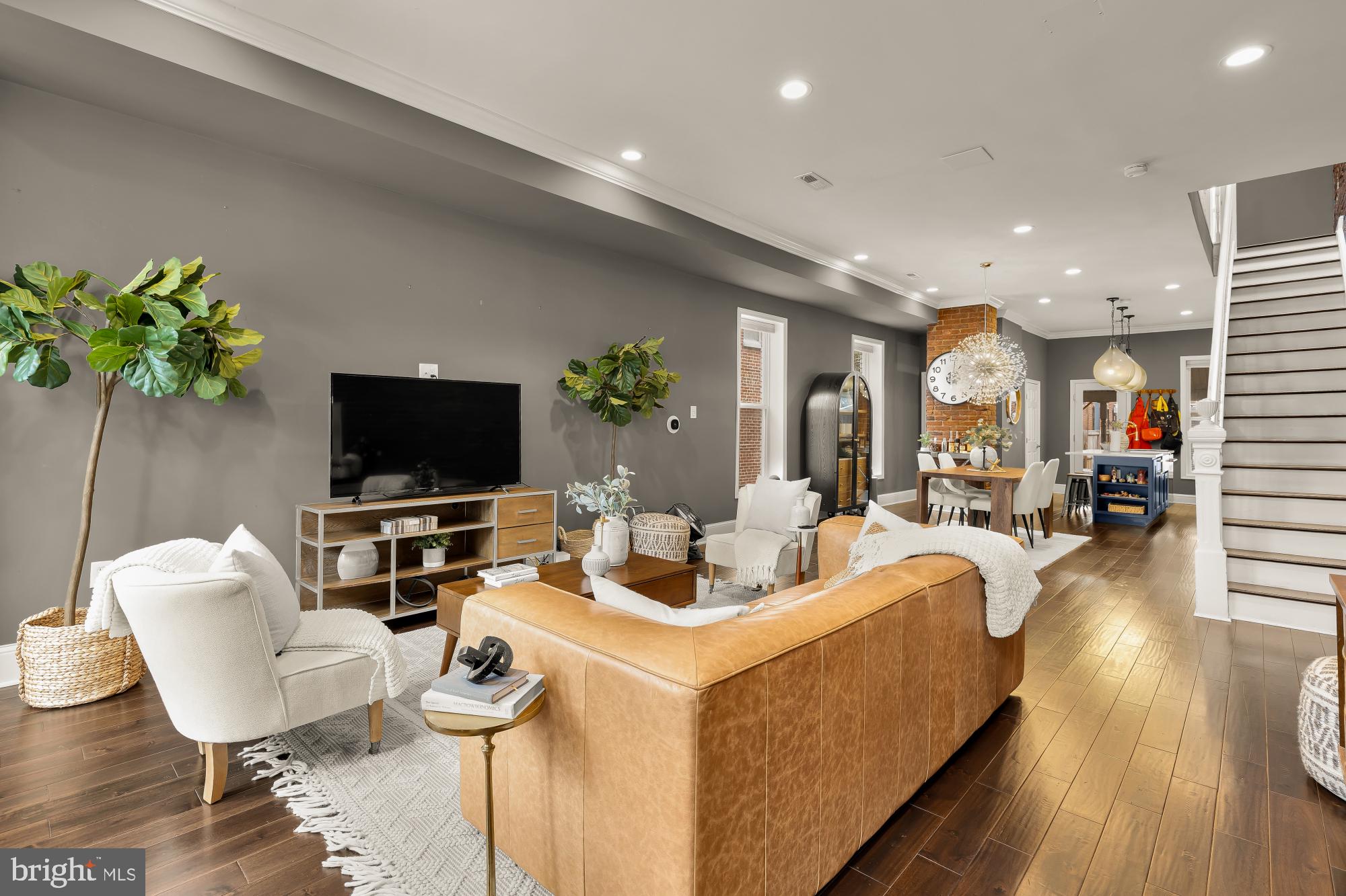 421 10th Street Northeast Washington, DC 20002 - Photo 8 of 61 a living room with furniture a flat screen tv and a potted plant