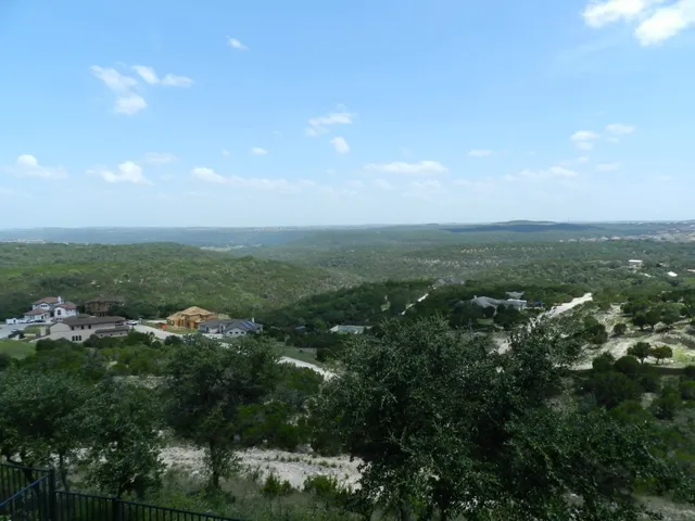 an aerial view of house with yard and mountain view in back
