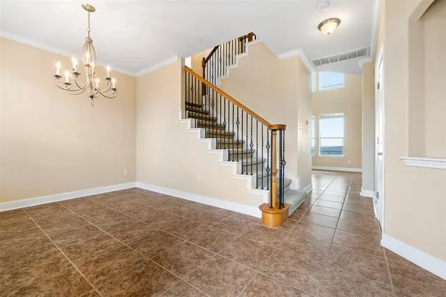 a view of an empty room with wooden floor fireplace and a window