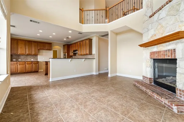 a kitchen with granite countertop cabinets stainless steel appliances a sink and a window