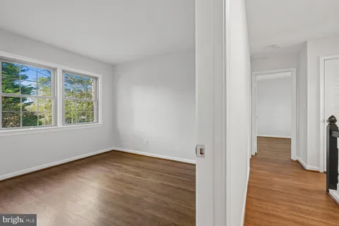 a view of a room with wooden floor and window