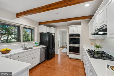 a kitchen with stainless steel appliances a sink a stove and a refrigerator