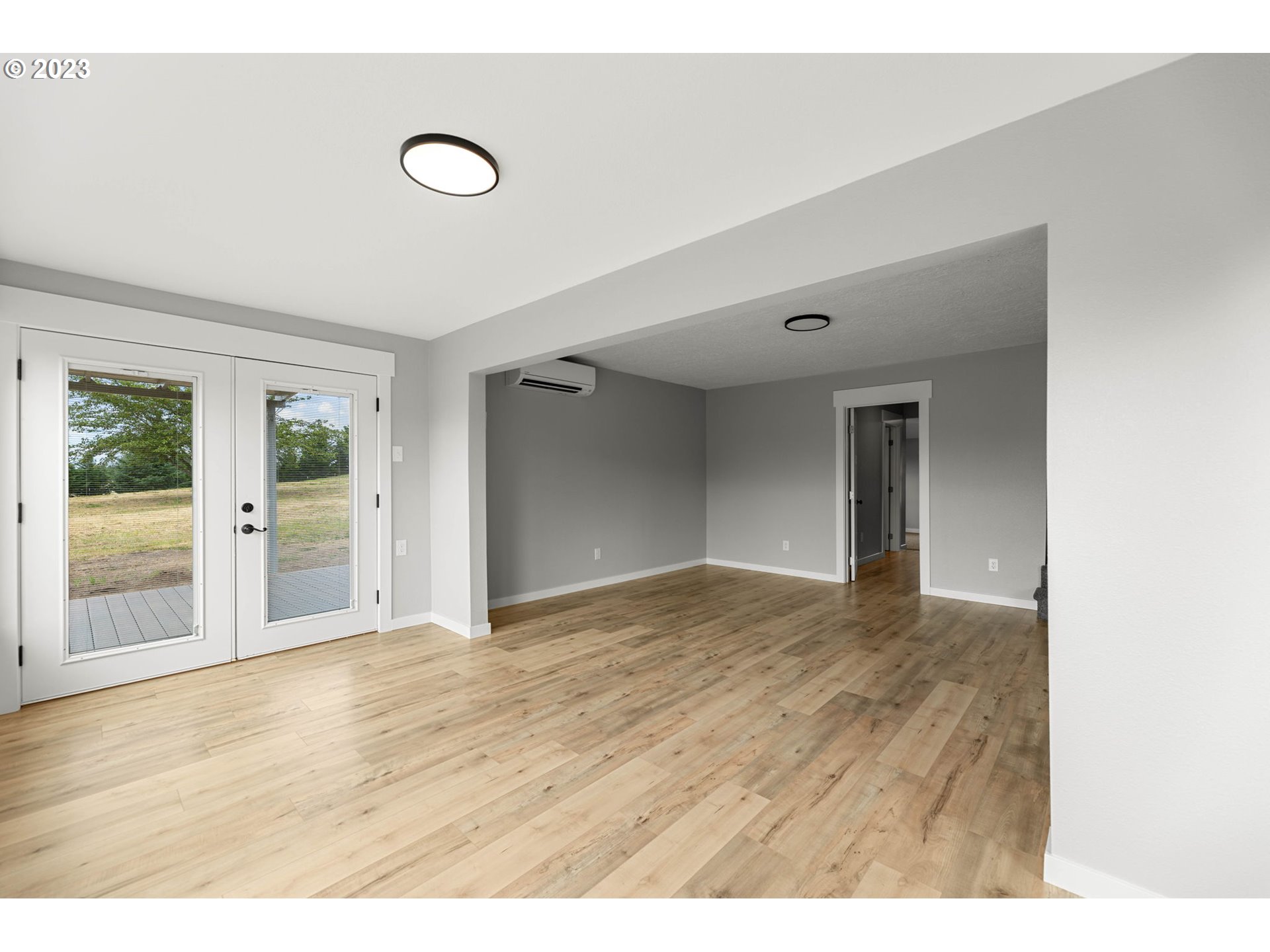 19308 Northeast Davis Road Brush Prairie, WA 98606 - Photo 4 of 45 a view of an empty room with wooden floor and windows