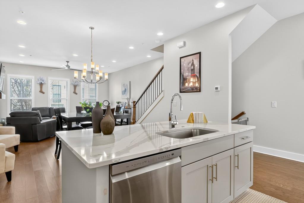 304 Liberty Way Woodstock, GA 30188 - Photo 11 of 42 a kitchen with stainless steel appliances a sink and living room view