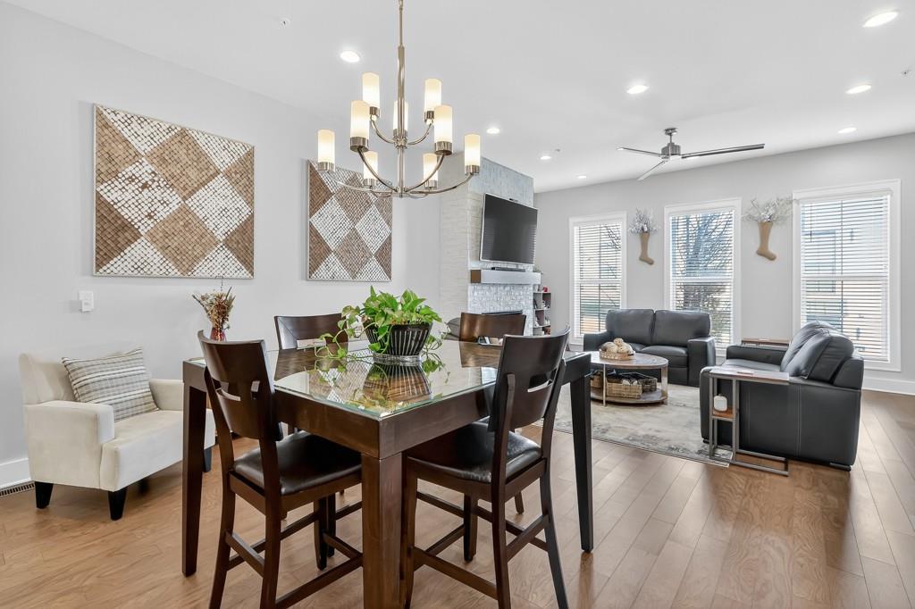 304 Liberty Way Woodstock, GA 30188 - Photo 12 of 42 a view of a dining room with furniture and wooden floor