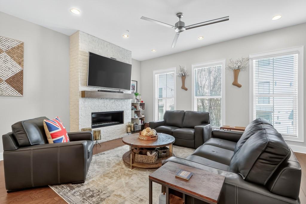 304 Liberty Way Woodstock, GA 30188 - Photo 15 of 42 a living room with furniture a flat screen tv and a fireplace