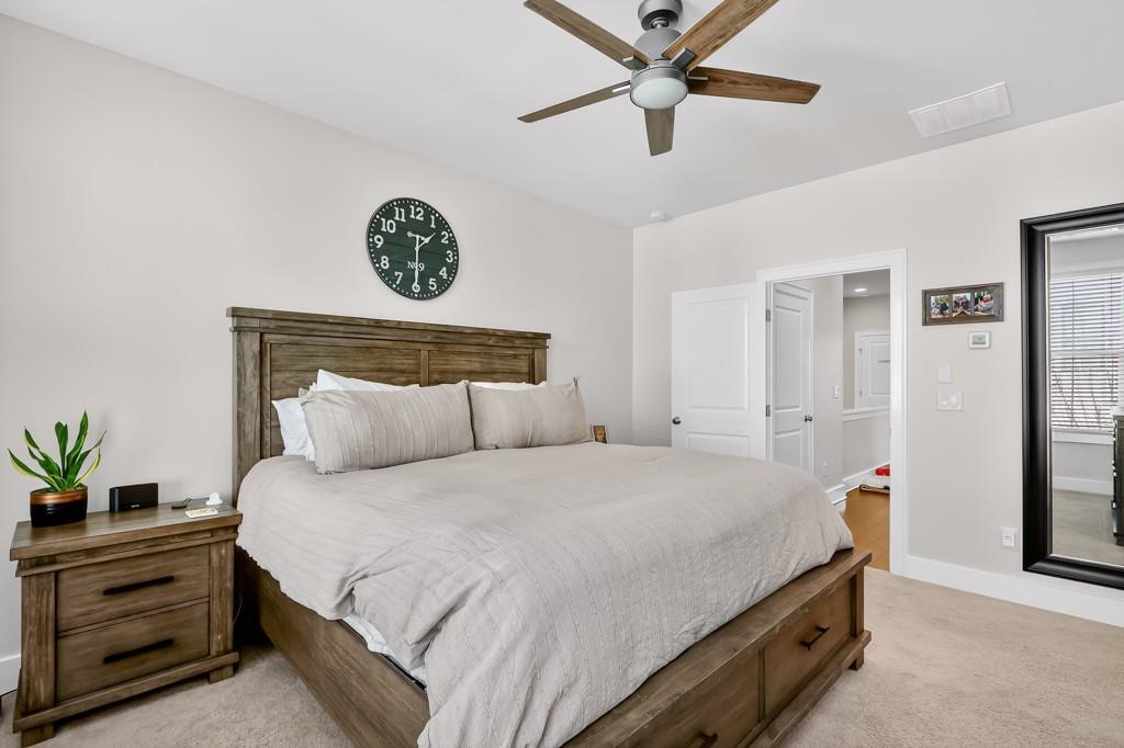 304 Liberty Way Woodstock, GA 30188 - Photo 19 of 42 a bedroom with a bed and a chandelier