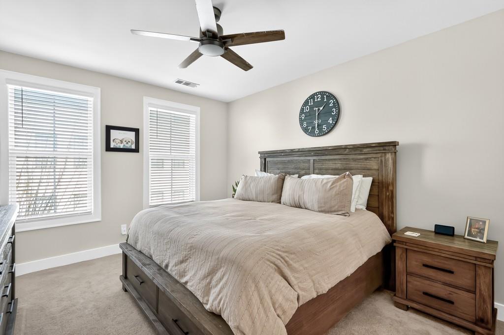 304 Liberty Way Woodstock, GA 30188 - Photo 20 of 42 a bedroom with a bed and a chandelier