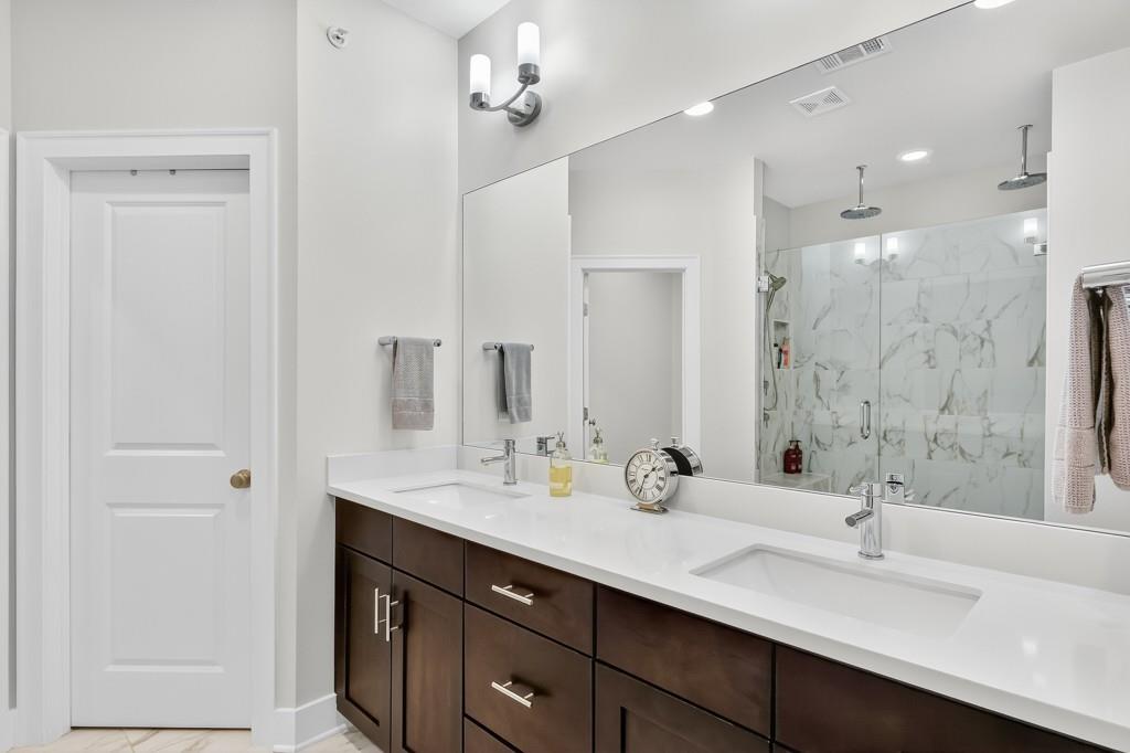 304 Liberty Way Woodstock, GA 30188 - Photo 21 of 42 a bathroom with a sink double vanity and a mirror