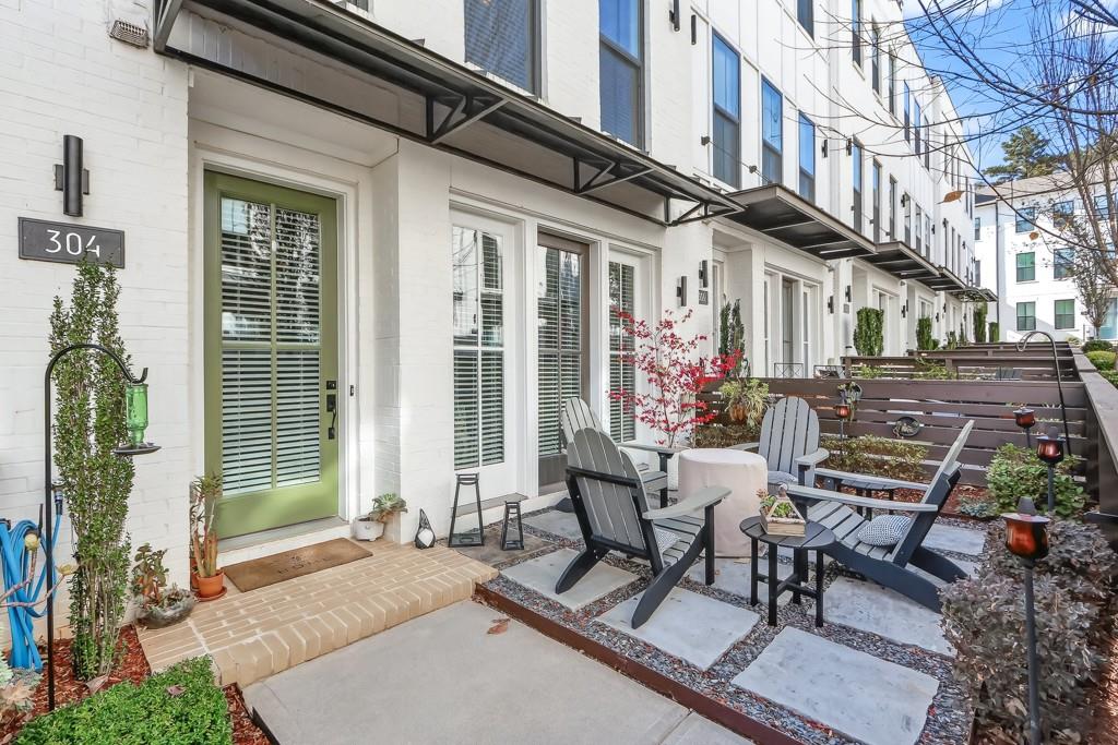 304 Liberty Way Woodstock, GA 30188 - Photo 3 of 42 a view of a patio with table and chairs and potted plants