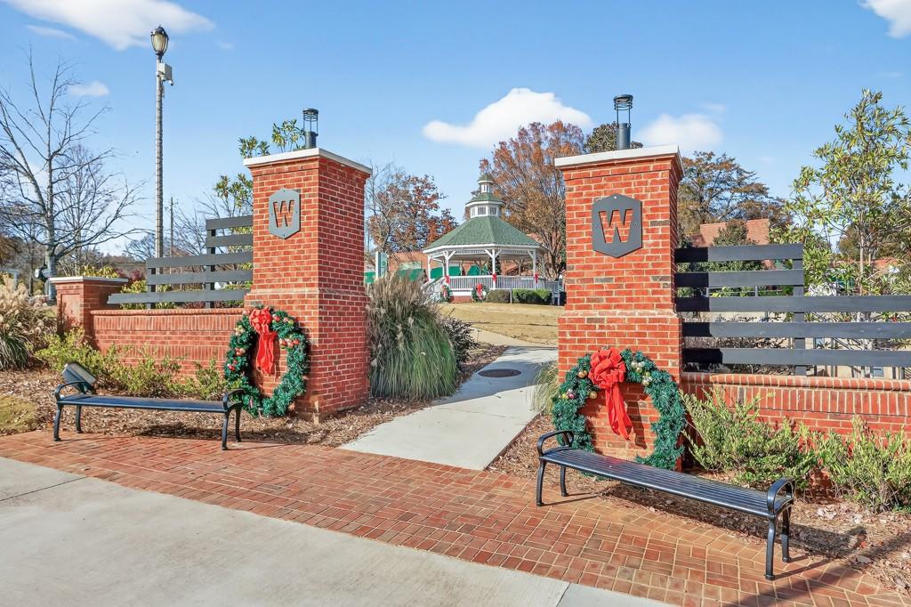 304 Liberty Way Woodstock, GA 30188 - Photo 32 of 42 a sign board with buildings in the background