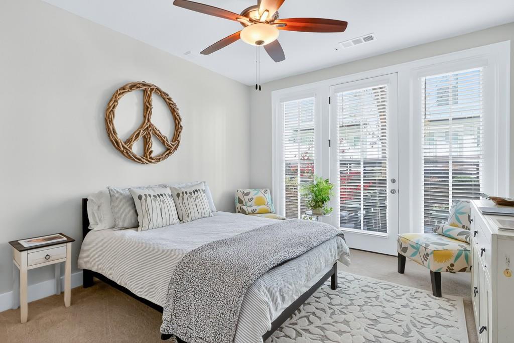 304 Liberty Way Woodstock, GA 30188 - Photo 5 of 42 a bedroom with a bed a chandelier and a window